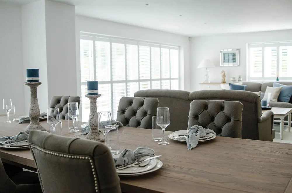 White shutters fitted on patio doors in a dining room