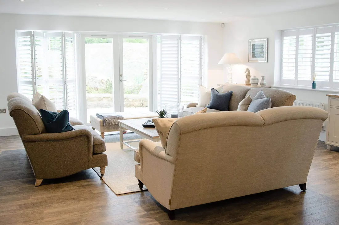 Shutters across a wide opening onto a garden