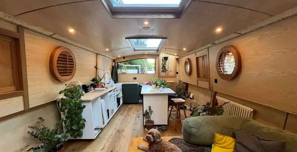 Timber porthole shutters fitted along a narrowboat cabin