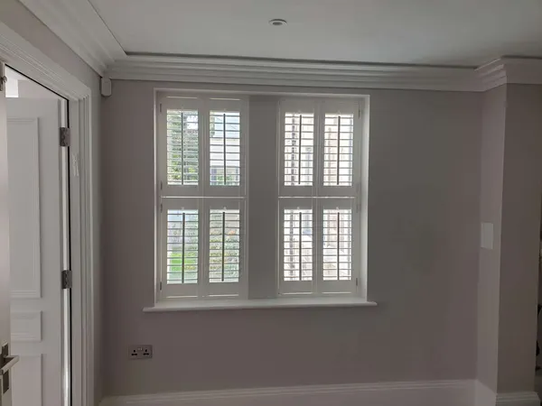 A pair of tier-on-tier shutters on a landing window
